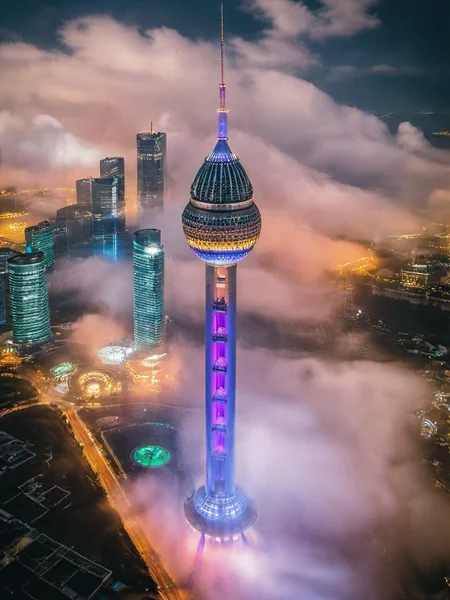 realistic, aerial photograph, cloud, tower, night, neon light, <lora:ap1-000024:0.8>