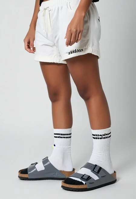 photorealistic, masterpiece, best quality.
1girl, solo, simple_background, white_background, standing.
calves, thighs, adidas_shorts, lower_body, slippers, footwear_focus, scksnsndls, birksonsocks, black_socks.