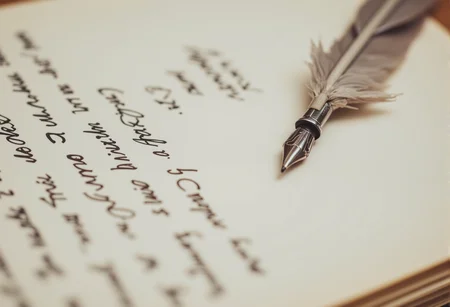 A close-up of a delicate quill pen, its tip dipped in ink, lying next to an open journal filled with elegant handwriting. bv-daraca<lora:bv-dark-academia-v1.safetensors:1.0:1.0>