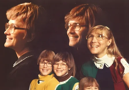 a family of four, double exposure effect, a80psdxl, dark background, <lora:a80psdxl:1>, cheesy smiles, nerdy family,