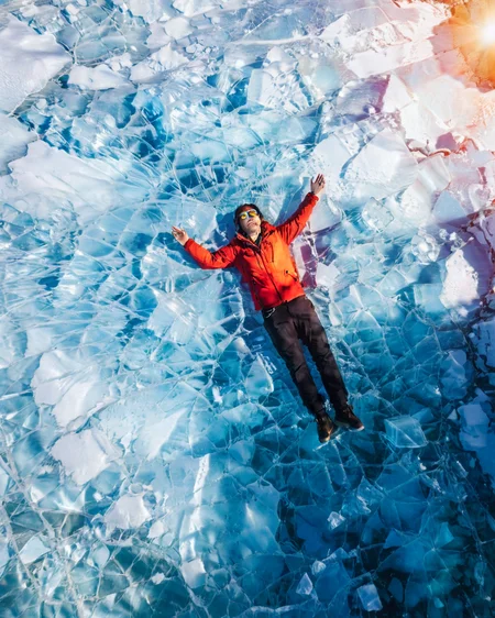 vertical perspective aerial photography, sunlight_shadow, blue ice, looking_up, lying_down, <lora:sky:0.8>