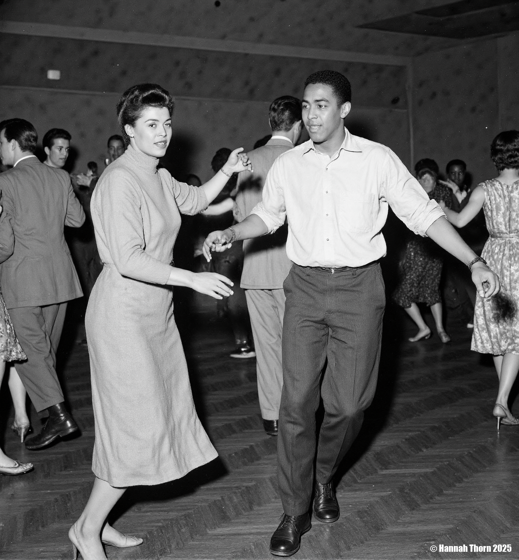 The picture is a black and white photograph depicting a lively dance scene, likely at a social event or club in the mid-20th century.  The focus is on a young Afro-American couple dancing. The woman, wearing a simple, elegant sweater and a knee-length skirt, is moving with grace. Her partner is stylishly dressed in a light-colored shirt and dark trousers. He appears to be leading the dance.  In the background, other couples and people are visible, enjoying the music. A saxophone player is noticeable amidst the dancers, indicating a jazz or swing atmosphere. The background is blurred, drawing attention to the main dancing couple in the foreground. The overall style suggests candid photography, capturing the spontaneous energy of the moment. The photographic style is reminiscent of photojournalism or street photography from the mid-20th century. The use of black and white enhances the contrast and mood, creating a timeless quality. The slightly grainy texture and focus on capturing movement in a realistic manner further contributes to the authenticity of the scene. The shallow depth of field keeps the focus sharply on the central dancing couple while maintaining enough context through the slightly blurred background.  The composition, with the central couple framed in the dance floor, guides the viewer's attention effectively. <lora:_Flux\Vintage_Jazz-Club.safetensors:1.0:1.0>